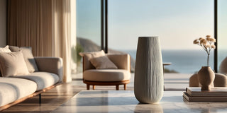 Empty tall ceramic vase for floral arrangements styled in a sunlit modern interior with soft neutral tones
