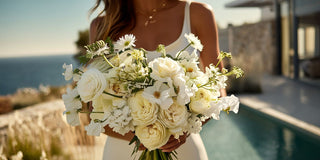 Romantic bridal bouquet with white roses and delicate blooms in soft natural light