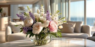Spring floral arrangement with pastel tulips, peonies, and lilac tones in a light-filled interior