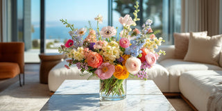 Summer floral arrangement with colorful garden flowers in a bright modern coastal interior