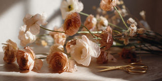 Luxury floral styling accessories featuring gold floral scissors and faux ranunculus stems in warm neutral tones by True Bloom Floral™