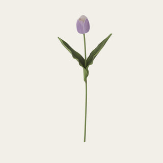 Light purple real touch tulip stem shown in full view with a closed lavender tulip bloom, broad faux green leaves, and a wired green stem for petite vases, spring arrangements, narrow-neck vessels, and soft floral styling