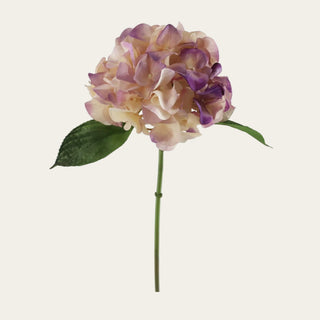 20 inch real touch purple and cream hydrangea stem shown on a warm cream background with a full rounded bloom, soft lavender-purple petal tips, creamy ivory petals, green faux leaves, and a long single stem for realistic faux floral styling.