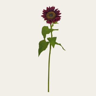 Burgundy faux sunflower stem shown in full view with a rich dark red flower head, textured center, faux green leaves, and long wired stem for fall arrangements, statement vases, warm seasonal styling, and tall faux floral designs.