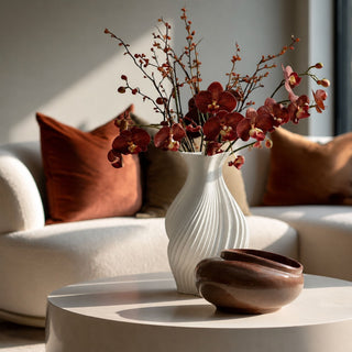 Brown Real Touch Orchid Stems styled with autumn berry branches in a white statement vase for a warm fall living room floral arrangement.