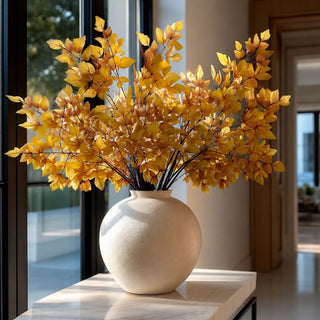 32 Inch Yellow cimicifuga stems styled in a large textured round vase on a marble console table with sun lit stems 