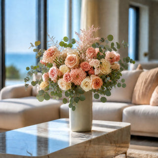 32 inch round eucalyptus stem styled in a soft neutral faux floral arrangement with blush, peach, ivory, and cream blooms in a tall ceramic vase, adding airy shape, realistic greenery, and natural movement to elegant living room floral styling.
