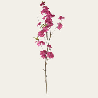 36 inch fuchsia cherry blossom branch with wired faux stem, designed to add height, color, and movement to spring and summer arrangements with tulips, ranunculus, hydrangeas, roses, and greenery.
