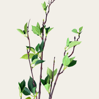 Close-up of 46 inch green leaf branch with realistic faux leaves and branching structure, designed to pair with cream hydrangeas, white peonies, ranunculus, dahlias, and seasonal greenery for fresh spring, summer, and fall floral arrangements.