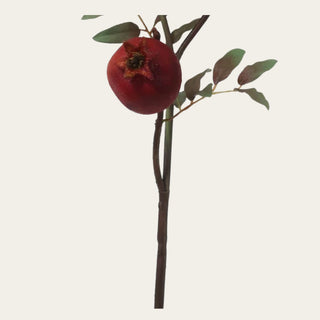 Stem detail of an artificial burgundy faux dried pomegranate branch showing realistic faux fruit, wired branching, and natural foliage for seasonal home décor.