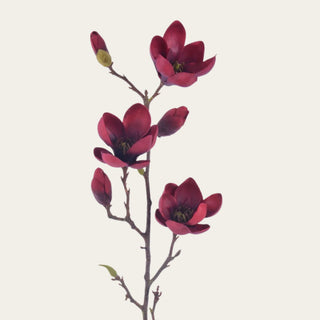 Close-up of an artificial burgundy faux magnolia tree stem featuring realistic magnolia blooms, buds, and natural branching for designer floral styling.