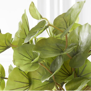 Close-up of an artificial green leaf spray featuring realistic faux botanical foliage, natural veining, and layered greenery for designer floral styling.