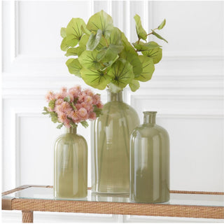 Artificial green leaf spray styled in an olive glass vase with realistic faux greenery for modern home décor and year-round floral arrangements.
