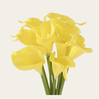 Close-up of artificial Real Touch yellow calla lily blooms showcasing sculptural trumpet-shaped flowers, realistic faux texture, and vibrant yellow color.