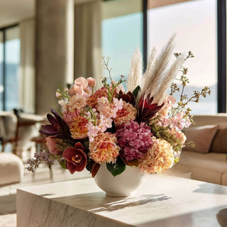 Fall faux floral arrangement in a white vase on styled in a modern