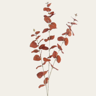 Close-up of the brown and orange faux eucalyptus spray highlighting realistic rounded leaves, layered branching, and warm seasonal foliage for designer floral arrangements.