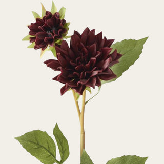 Close-up of burgundy real touch dahlia blooms showing layered petals, deep seasonal color, and a soft floral surface with realistic faux leaf detail.
