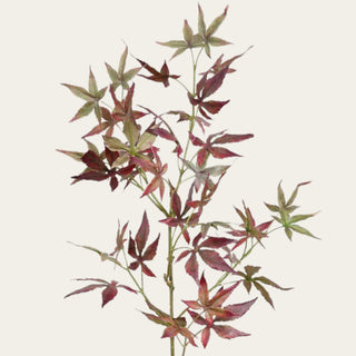 Close-up of burgundy and green faux Japanese maple leaves showing pointed shapes, varied seasonal coloring, fine texture, and natural placement along flexible branches.