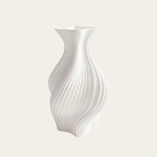 Ceramic White 3D printed sculptural Calista vase styled on a plain off white background 