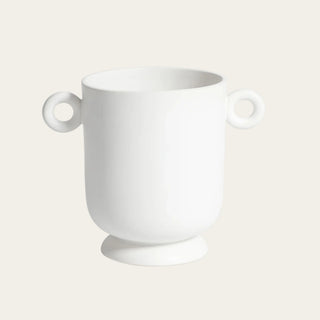 Large white ceramic loop handle vase with rounded vessel shape, raised base, smooth finish, and sculptural circular handles