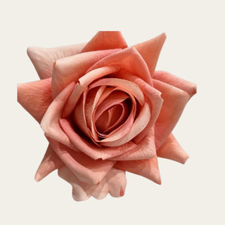 Close-up of a coral True Bloom duchess rose bloom showing soft real touch petals, layered ruffled detail, and warm coral coloring