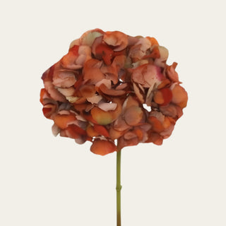 Close-up of a realistic artificial faux dried antique brown hydrangea bloom showcasing naturally aged petals and lifelike texture for luxury floral arrangements.