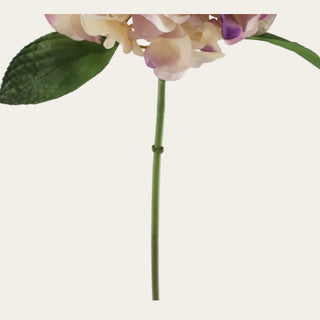 Detailed close-up of the real touch purple and cream hydrangea bloom showing layered faux petals with creamy ivory coloring, soft blush-lilac variation, deeper purple petal tips, and a lifelike rounded hydrangea shape.