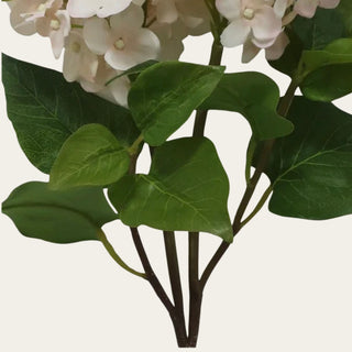 Close up of the cream True Bloom lilac stem showing realistic green leaves, branch-style stems, veining, texture, and construction detail for lifelike floral styling.