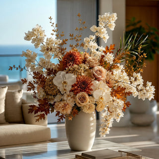 Creamy white faux bougainvillea stems arranged with warm autumn florals, deep burgundy accents, and layered greenery in a tall ceramic vase for an elevated fall faux floral arrangement