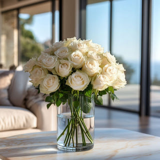 A luxury faux white rose bouquet in a glass vase, styled on a marble table in a bright coastal living room