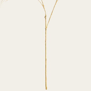 Close-up of the 36-inch gilded faux fern's wired gold stem construction, designed to support shapeable branching and directional floral styling.