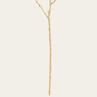 Close-up of the 27-inch gilded magnolia's wired and shapeable gold stem with textured branching designed for flexible positioning in floral arrangements.