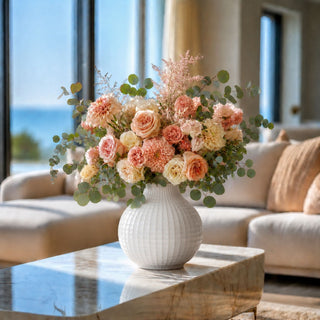 11.5 Inch high glossy white woven style vase in an arrangement styled on a marble coffee table in a luxury modern home with creamy colored furnishings and decor. 