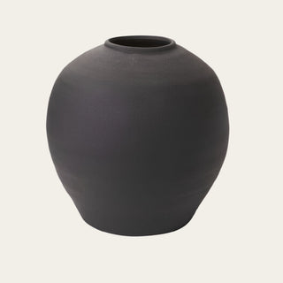 Large Black Konos Vase shown in full view with a rounded concrete form, matte black textured finish, and wide vessel opening, designed for statement faux floral arrangements, tall branches, and large-scale tabletop styling.