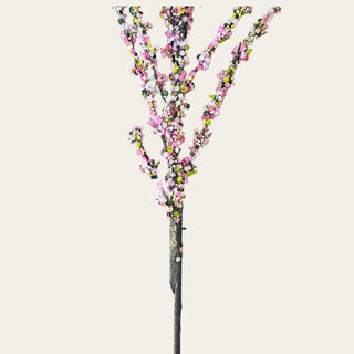 Detailed view of pink confetti blossom branch stem base showing realistic textured faux branching and layered blossom placement for artistic spring floral styling.
