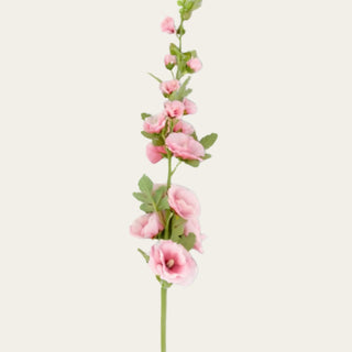 Close-up detail of pink faux hollyhock blooms showing layered petals, soft tonal variation, and velvet-textured foliage for romantic garden-inspired floral arrangements.