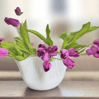 Purple True Bloom real touch tulips arranged in a white vase with soft green leaves and naturally curved stems for a rich year-round faux floral centerpiece.
