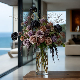 Real Touch Black sedum Stem styled in a designer floral arrangement in clear glass vase on a wood table in a living room
