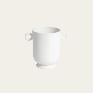 Small white ceramic loop handle vase with rounded vessel shape, raised base, smooth finish, and sculptural circular handles