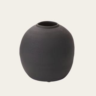 Small Black Konos Vase shown in full view with a rounded concrete silhouette, matte black textured surface, and open top, designed for tabletop faux floral arrangements, seasonal stems, and everyday home styling.