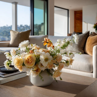 Pale yellow True Bloom Duchess Roses styled with white peonies, white anemones, and airy greenery in a modern living room arrangement; works beautifully year-round and during the holidays because the soft yellow blooms add warmth while blending naturally with neutral florals and layered seasonal palettes.