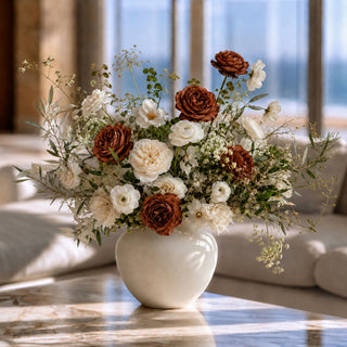 Luxury faux dark mocha rose floral arrangement featuring Real Touch black garden roses, ivory roses, white ranunculus, lisianthus, olive branches, and preserved botanicals styled in a modern ceramic vase for elegant home décor.