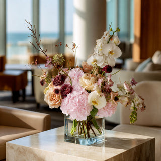 Light pink real touch hydrangea stems styled in a glass vase with soft neutral florals and greenery, creating a warm spring, summer, or early fall arrangement that works beautifully with ivory, champagne, cream, and muted seasonal tones.