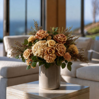 Tan w/ orange True Bloom real touch roses styled with cream hydrangeas, warm neutral florals, greenery, and textured filler stems in a warm neutral vase for an elevated faux floral arrangement.