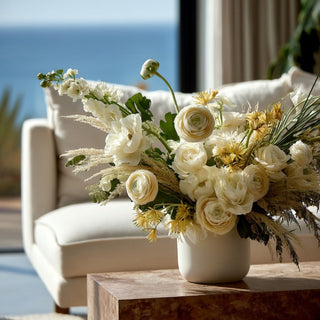 Cream True Bloom Real Touch ranunculus stems arranged in a white ceramic vase with soft ivory and blush florals for an elevated bridal-inspired faux floral centerpiece