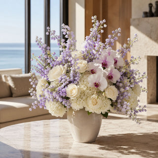 Real Touch Light Purple Lily of the ValleyStem Bundle styled in an arrangement in a vase on a marble coffee table in a luxury modern coastal home with ocean views. 