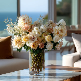 Styled in an arrangement cashmere cream true bloom real touch dahlia stem in a vase on a marble table in a luxury coastal home