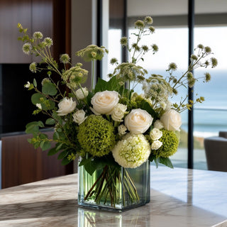 Green and white real touch globe amaranth spray stem in a luxury floral arrangement on a marble table in a modern coastal home