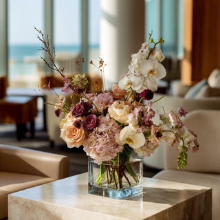 Light peach real touch hydrangea stems styled in a glass vase with soft neutral florals and greenery, creating a warm spring, summer, or early fall arrangement that works beautifully with ivory, champagne, cream, and muted seasonal tones.
