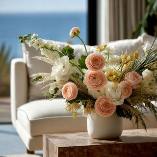 True bloom peach ranunculus strem tripple blossoms mixed with other florals in a luxury floral arrangement; works beautifully in spring, summer, and fall because the saturated fuchsia blooms create focal contrast while softer florals balance the overall design.